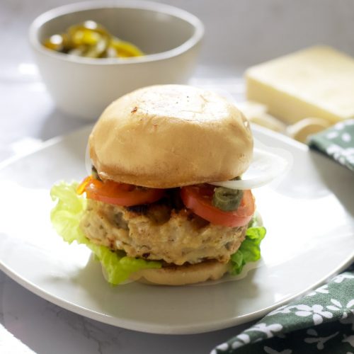 gluten-free spicy chicken burger with lettuce, tomato, onion, mayo