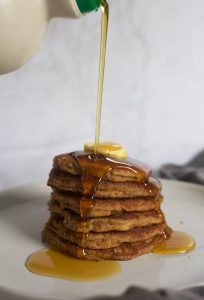 fluffy, light, pumpkin pancakes with syrup and butter on top