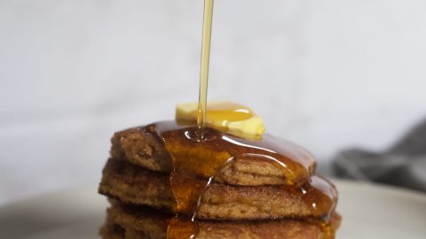 fluffy, light, pumpkin pancakes with syrup and butter on top
