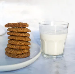 A stack of chewy peanut butter cookies and a glass of milk