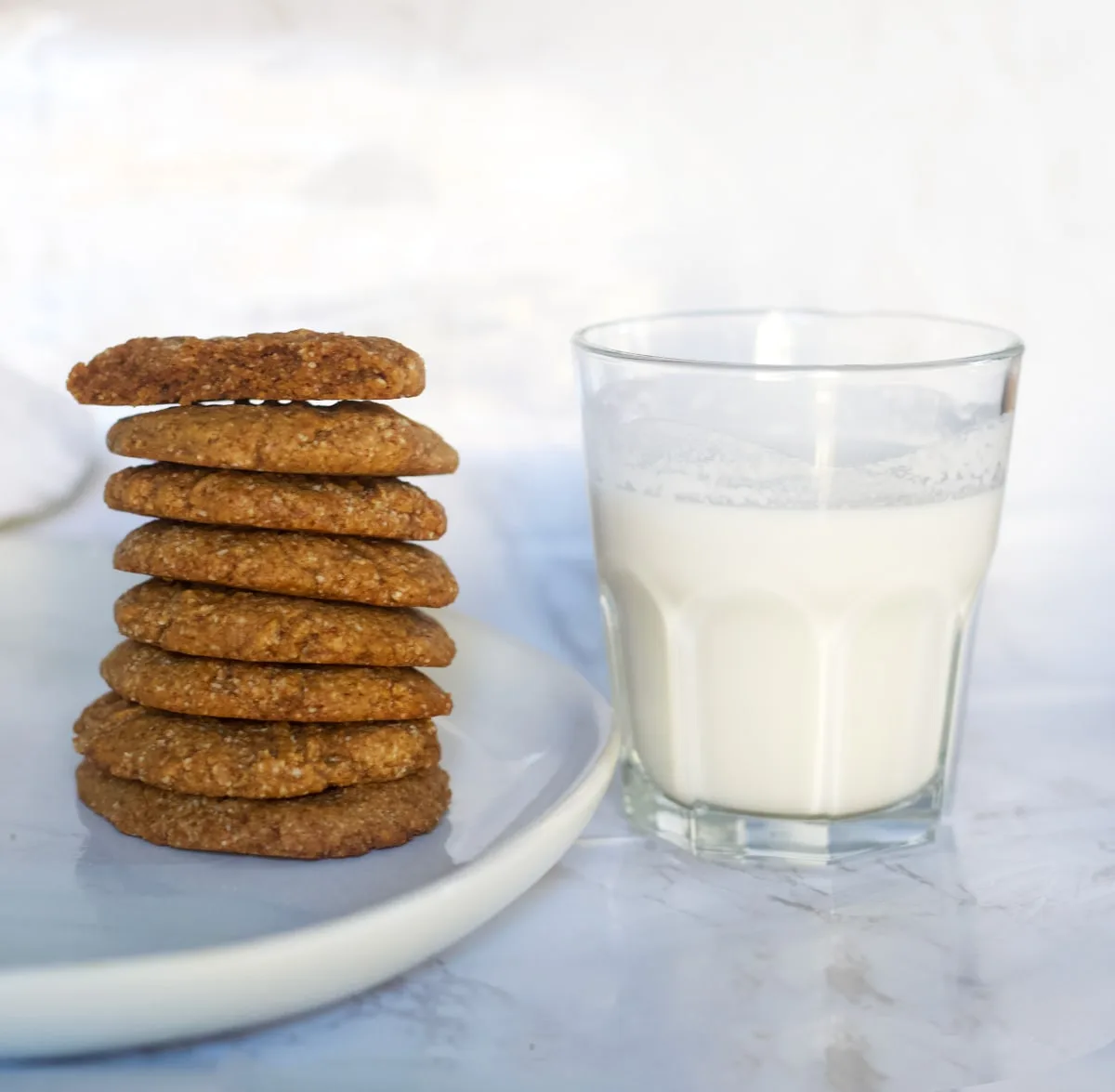 A stack of chewy peanut butter cookies and a glass of milk