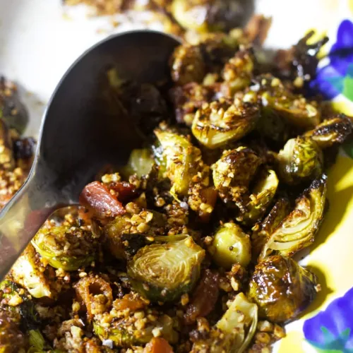 crispy brussel sprouts with bacon crumbles, blasamic glaze and pecan crumble topping