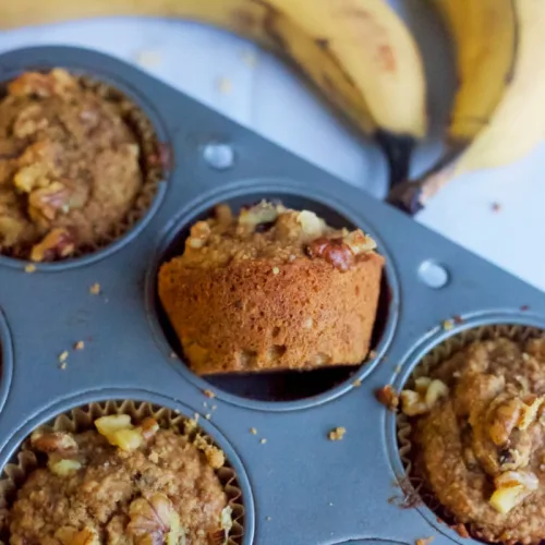 fluffy banana nut muffins in a muffin pan