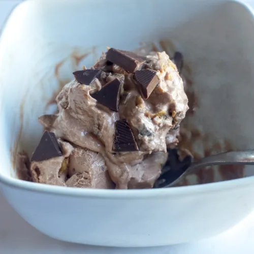 3 scoops of cottage cheese creamy chocolate ice cream with chopped chocoalte and peanut butter on top