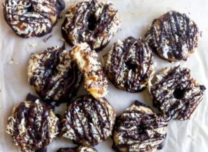 chocolate coocnut caramel cookies on parchment paper