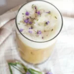 an iced lavender coffee with lavander buds on top