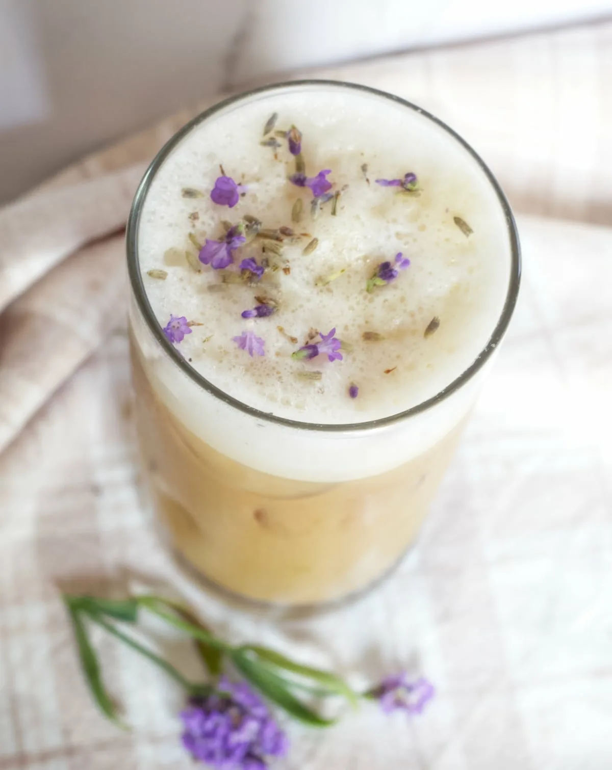 an iced lavender coffee with lavander buds on top