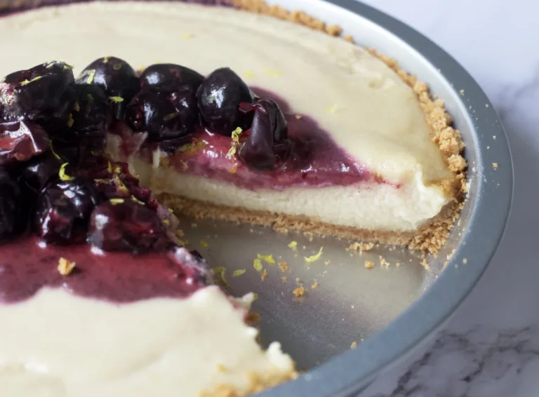 cheesecake with a graham cracker crust and cherries on top