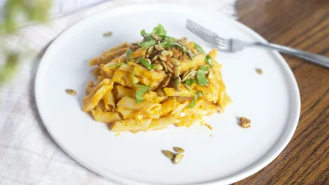 pumpkin pasta on a plate with a fork